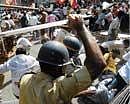 when might rules: Police baton-charge demonstrators during a protest over a decision to cut water supply by 15 per cent in Mumbai on Thursday . AFP