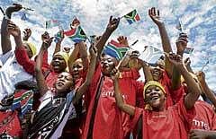 Children cheer as they pose for photographers before a FIFA  meeting in Robben Island on Thursday. AP