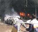 Vehicles are seen on fire after a blast in Peshawar market on Saturday. AP