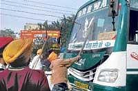 Sikh protesters damage buses after police stopped a religious programme in Ludhiana on Saturday. PTI