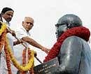 Chief Minister Yeddyurappa garlanding Dr B R Ambedkars statue  in Bangalore on Sunday. dh photo