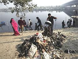 Schoolchildren participate in a drive to clean the polluted River Yamuna in New Delhi on Saturday. AP