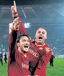 AS Roma's Daniele De Rossi (right) and Francesco Totti celebrate their victory against Lazio on Sunday. Reuters