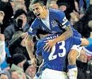 Everton's Tim  Cahill celebrates with team-mate Lucas Neill after scoring  the equaliser in their draw against Tottenham Hotspur on Sunday. AFP