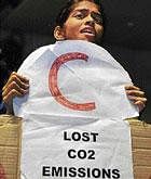 Environmental activist holds a banner to protest against lost emissions that threaten the livelihoods of future generations at the Bella center in Copenhagen on Tuesday.  AFP