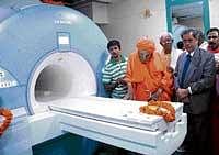 Sri Shivakumar Swamiji and MD of Kanva Diagnostic Services Dr H M Venkatappa at the inauguration of CT and MRI facilities at Rajajinagar in Bangalore on Thursday.  DH Photo