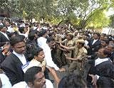 Policemen try to break a tussle between lawyers in support of  Telangana state and those against it, outside the High Court in Hyderabad on Friday. AP