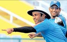 Virender Sehwag and Mahendra Singh Dhoni enjoy their fielding session at the PCA stadium in Mohali on Friday. AP