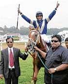 victorious Suraj Narredu celebrates after steering Sprint Star to victory in the Harvins Bangalore 2000 Guineas Trophy as owner Dr Syed Ainuddin (right) and trainer Satish Narredu lead in. DH photo