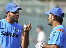 See this: Yuvraj Singh talks to captain Mahendra Singh Dhoni during a practice session in Rajkot on Monday. PTI