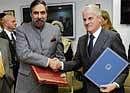 Business Bond: Union Commerce Minister Anand Sharma (left ) exchanging documents with Italian Economic development Minister Claudio Scajola in New Delhi on Monday. AFP