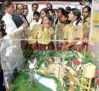 Young and Energetic: Energy Minister K S Eshwarappa interacting with schoolchildren at the National Energy Conservation Day programme in Bangalore on Monday. Energy department secretary K Jairaj is also seen. DH Photo