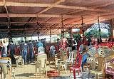 Volunteers removing chairs at the venue of Tulu Sammelana in Ujire on Monday. DH photo