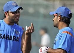 SMALL CRACK Yuvraj Singh shows his injured finger to     team-mates during a training session in Rajkot. AP