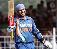 Virender Sehwag celebrates after completing his century during the first ODI match against Sri Lanka in Rajkot on Tuesday. PTI