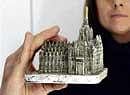 A girl holds a statuette of Milans Duomo gothic cathedral, similar to the one which hit Italian Prime Minister Silvio Berlusconi. REuters