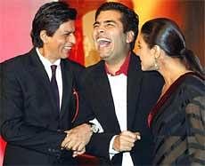 Actors Shahrukh Khan and Kajol along with director Karan Johar during the unveiling of the first look of their film 'My Name is Khan', in Mumbai on Wednesday night. PTI