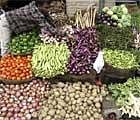 A vendor arranges vegetables at a market in Jammu. Reuters