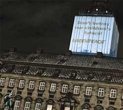 Activists from Greenpeace project their statement on the top of the parliament of Denmark in Copenhagen on Thursday. AP