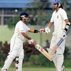 short and tall: Delhis Puneet Bisht (left) is congratulated by Ishant Sharma after reaching his century against Bengal on Friday. pti
