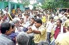 ANGST Hosahudya villagers gheraoing the officials alleging large-scale irregularities in implementing NREG scheme, in Bagepalli on Thursday. DH photo