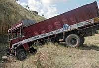 The lorry that fell into a trench after colliding with a tanker near Tallaghattapura Junction in Ramnagara district on Friday. DH Photo