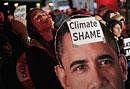 Demonstrators hold a picture of U.S. President Barack Obama during a demonstration outside the Bella Center, the venue of the U.N. Climate Conference in Copenhagen, Denmark, early on Saturday. AP
