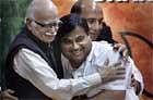 Bharatiya Janata Party's  veteran party leader L K Advani, left, hugs newly appointed party president Nitin Gadkari, on Saturday. AP  .