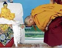 OBEISANCE Tibetan spiritual leader Dalai Lama prostrates in front of the statue of Buddha. He arrived in the City on Saturday to commemorate the first anniversary of Buddha Vihara, on the outskirts of Gulbarga. DH Photo