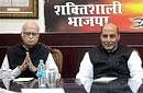 BJP senior leader L K Advani with outgoing BJP President Rajnath Singh at Parliamentary Board meeting at party office in New Delhi on Saturday. PTI