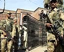 Pakistan army soldiers stand at the gate of the press club after a suicide attack in Peshawar on Tuesday. AP