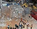 mishap at work: A column of a building came crashing down at Sadashivanagar on Wednesday, while it was being  demolished. dh Photo
