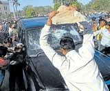 Protesters attack a vehicle on the Osmania University campus in Hyderabad on Thursday. AP