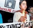 For a cause: A girl walks during a candle light procession demanding justice for Ruchika at Jantar Mantar in New Delhi on Thursday. PTI