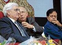 WHISPERING ACT: Governor H R Bhardwaj having a word with Union Minister Salman  Khursheed at a seminar on ' The Role of Minorities In Secular India' organised by the Bazm-e-Niswan Charitable Trust  in Bangalore on Thursday. Former Minister B K Chandrashekar is  also seen. DH Photo