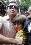 Sean Goldman arrives at the US Consulate in Rio de Janeiro hugs his Brazilian stepfather Joao Paulo Lins e Silva on Thursday. AP
