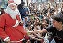Merry: Santa Claus entertaining children at the Christmas celebrations organised at the BOSCO Mane in Bangalore on Friday. dh photo
