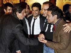 Bollywood actor Shahrukh Khan interacts with crew of the film '3 Idiots' Aamir Khan, Vidhu Vinod Chopra, R Madhavan and Sharman Joshi at premiere of the film in Mumbai. PTI