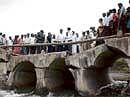 Tourism and District-in-Charge Minister G Janardhana Reddy and others inspecting the bridge at Moka village in Bellary taluk on Saturday, which collapsed on Friday. DH Photo