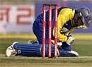 Sri Lanka's Tillakaratne Dilshan reacts in pain after he was hit by a ball from India's Zaheer Khan . AP