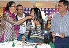 enjoying Aindrita Ray takes part in the cake-cutting ceremony.