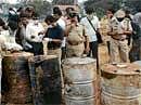 Experts examining the barrels containing chemicals at railway backyard near Srirampuram  in Bangalore on Tuesday. DH photo