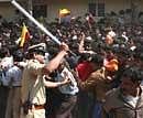 Police charge their battons to disperse the crowd gathered to pay tributes to Kannada actor Vishnuvardhan in Bangalore on Wednesday. PTI