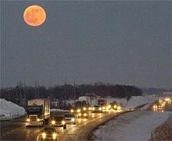 A blue moon rises over Interstate 80 west of Omaha, Neb., on Thursday. While not blue in colour, the second full moon in a calendar month is called a Blue Moon. AP