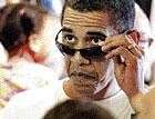 President Barack Obama looks over his sunglasses in Kailua, Hawaii, on Friday. AP