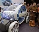 Delhi state Chief Minister Sheila Dikshit looks at a Renault Twizy Z.E. Concept car during a preview ahead of International Auto Expo, at her residence in New Delhi, India, Monday. AP Photo