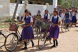 Girl students with the cycles provided by the government. dh photo
