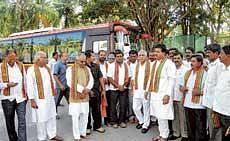 Chief Minister B S Yeddyurappa with MLAs arriving at a resort  on the outskirts of Bangalore for the BJP Legislature Party meeting on Monday. All of them travelled by bus. dh photo