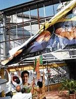 BJP workers in Mumbai tear a poster of the movie, 3 Idiots demanding the deletion of a suicide scene. PTI