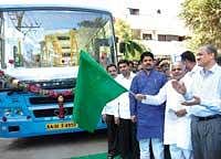 MLA M Srinivas flagging off a Volvo bus during the inauguration of Bande Maramma BMTC new bus stand at Nagarabhavi 9th block in the City on Tuesday. Transport Minister R Ashok and BMTC Managing Director Syed Zameer Pasha is seen. DH Photo
